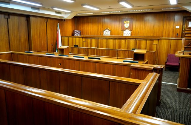 Interior of a courtroom, wood paneled