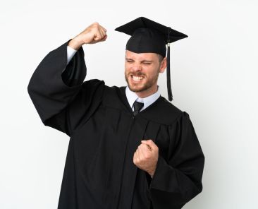 Young university Brazilian graduate isolated on white background celebrating a victory