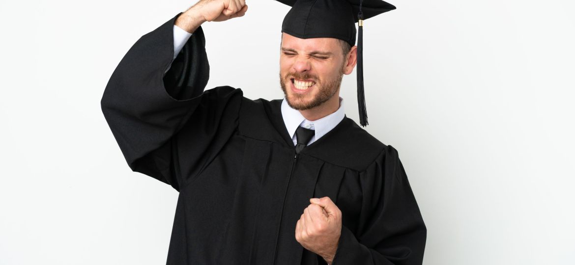 Young university Brazilian graduate isolated on white background celebrating a victory