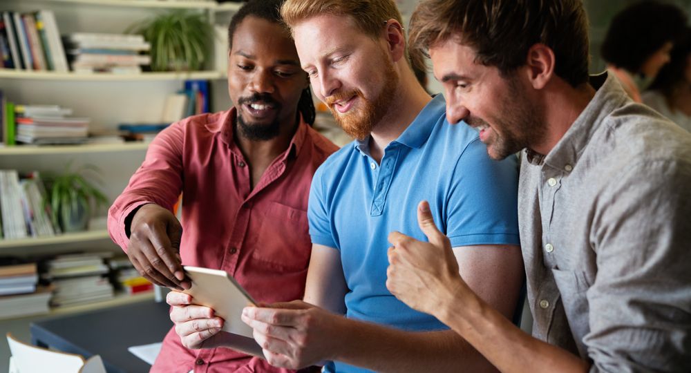 Group of happy startup business people having fun and chatting at workplace office